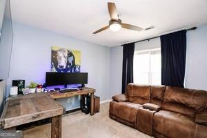 89 Copeland Road Newnan, GA 30263 - Photo 21 of 30 a living room with furniture and a flat screen tv