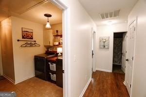 89 Copeland Road Newnan, GA 30263 - Photo 22 of 30 a view of a hallway with wooden floor and a living room