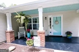 a front view of a house with outdoor seating