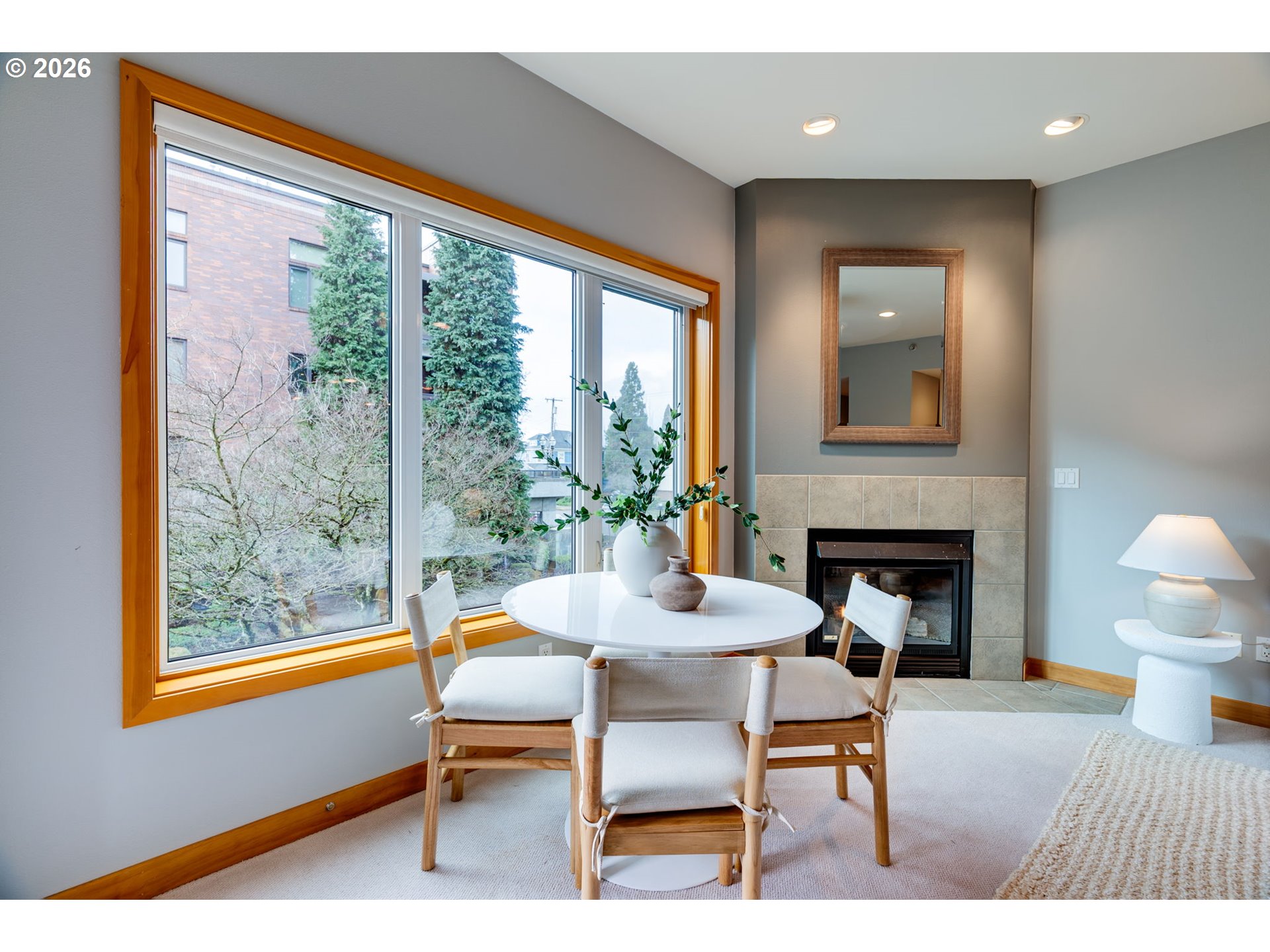 300 West 8th Street, Unit 236E Vancouver, WA 98660 - Photo 12 of 46 a living room with furniture a fireplace and a table