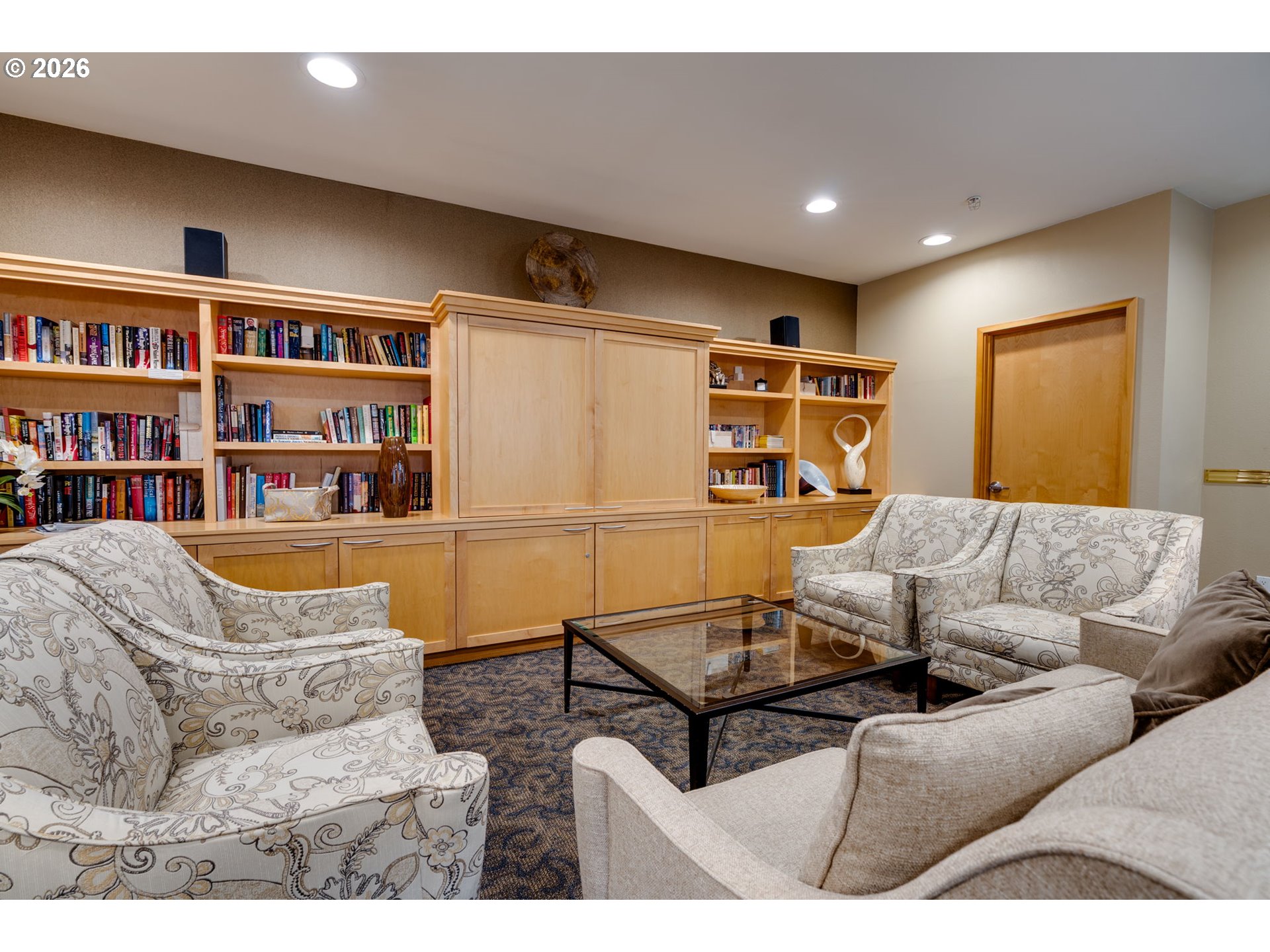 300 West 8th Street, Unit 236E Vancouver, WA 98660 - Photo 32 of 46 a living room with furniture and a book shelf