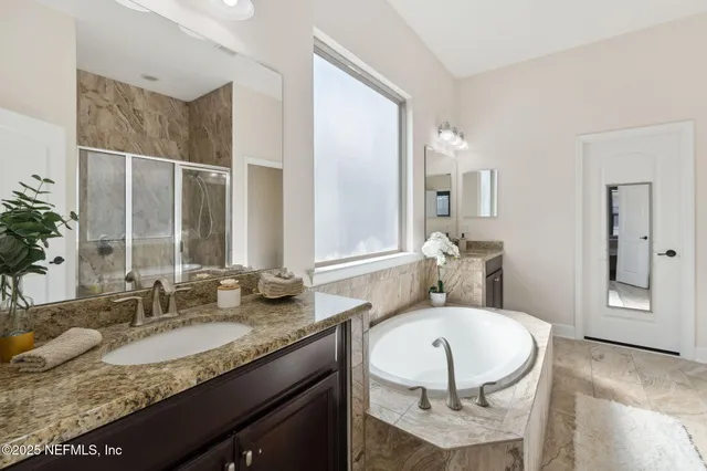 a front view of a house with yard and parking