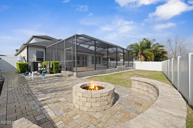 a view of a hallway with wooden floor and a bathroom