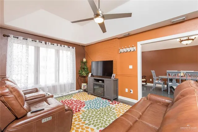 a living room with furniture and a flat screen tv