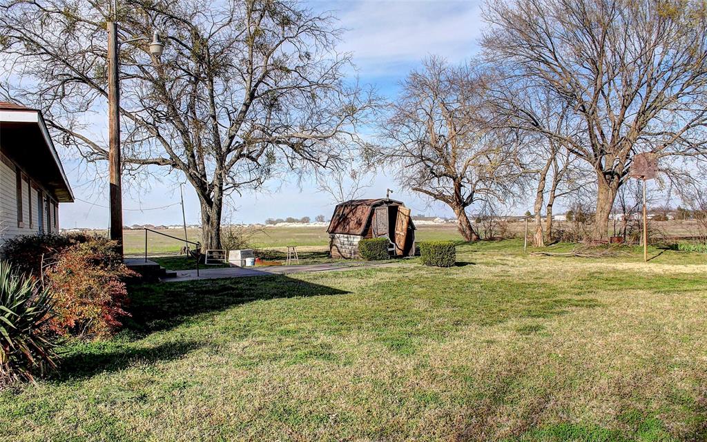 512 North Sherley Road Anna, TX 75409 - Photo 20 of 20 a front view of a house with garden and trees