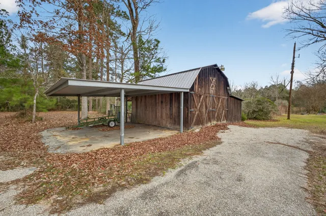 a backyard of a house with barbeque oven table and chairs