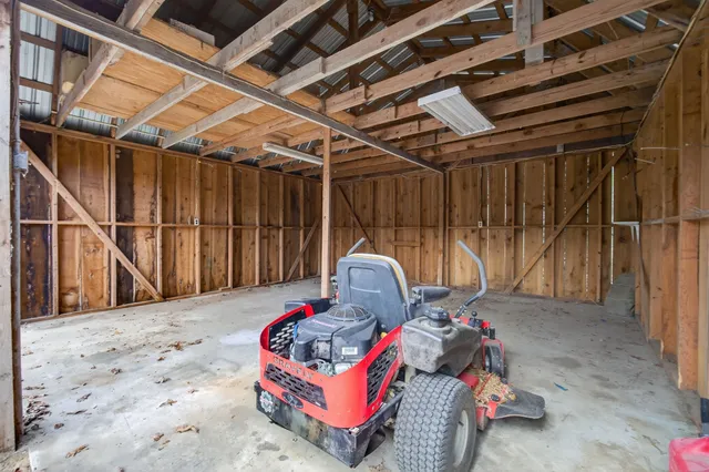 a backyard with wooden fence and a large tree