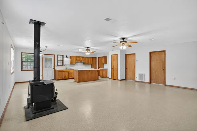 a view of a livingroom with furniture and a ceiling fan