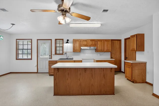 a view of kitchen with stainless steel appliances granite countertop lots of counter top space