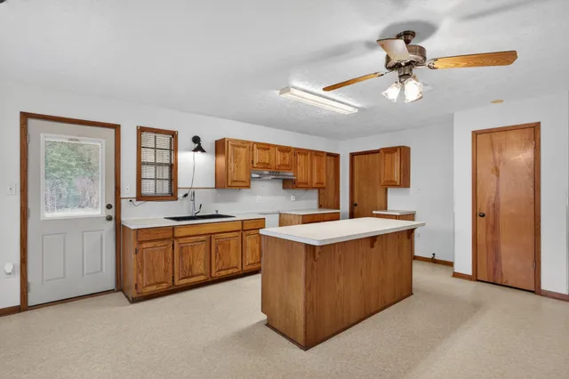 a kitchen with stainless steel appliances granite countertop a stove and a sink