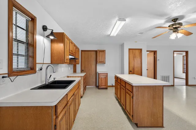 a kitchen with a sink stove and cabinets