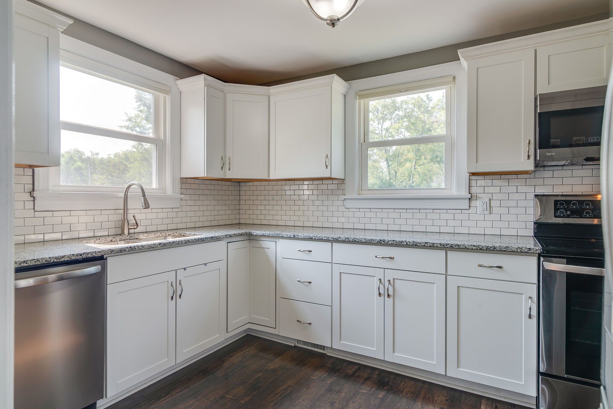 212 Neelys Bend Road Madison, TN 37115 - Photo 9 of 24 a kitchen with white cabinets a sink and a window