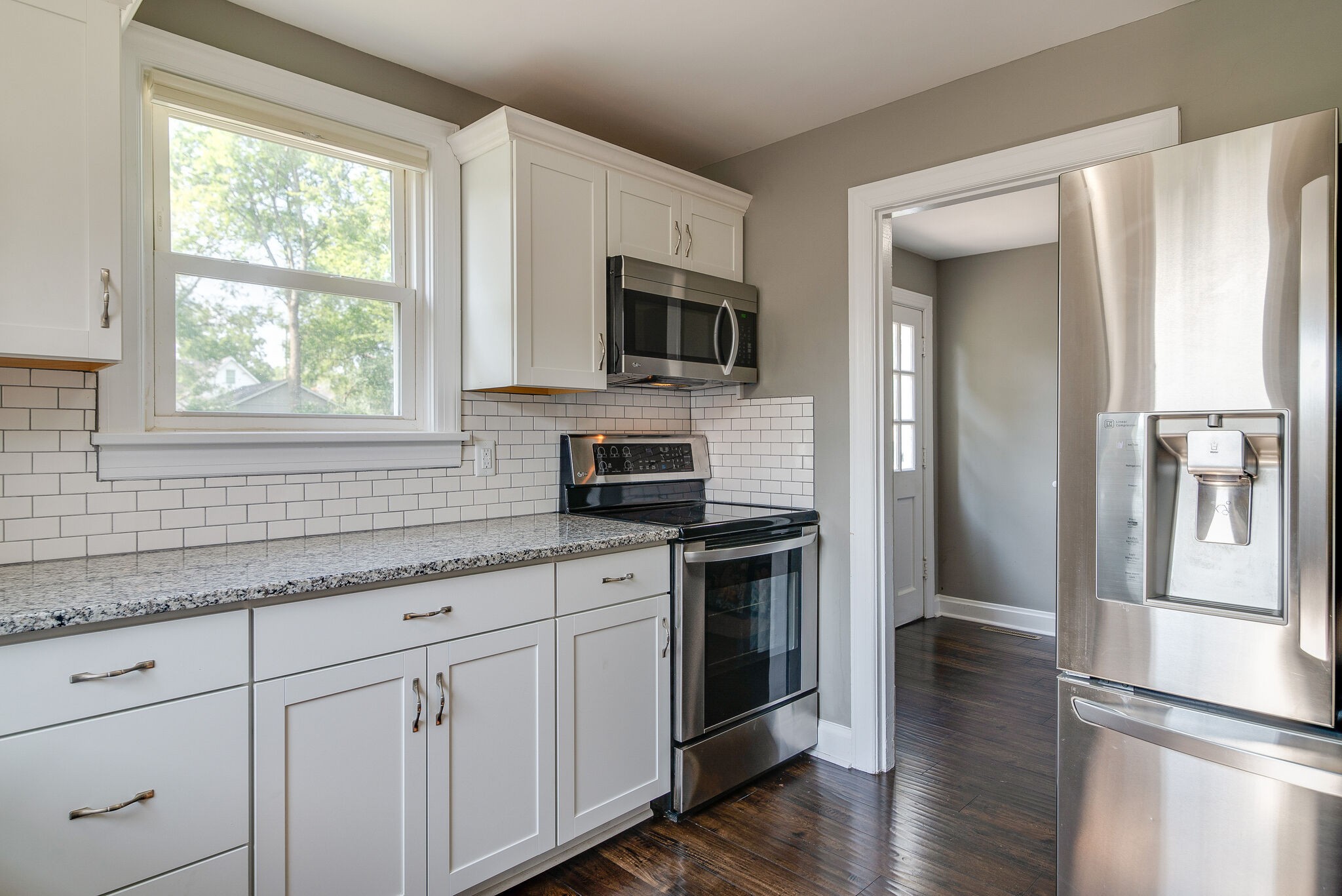 212 Neelys Bend Road Madison, TN 37115 - Photo 10 of 24 a kitchen with stainless steel appliances granite countertop a stove a sink and a microwave