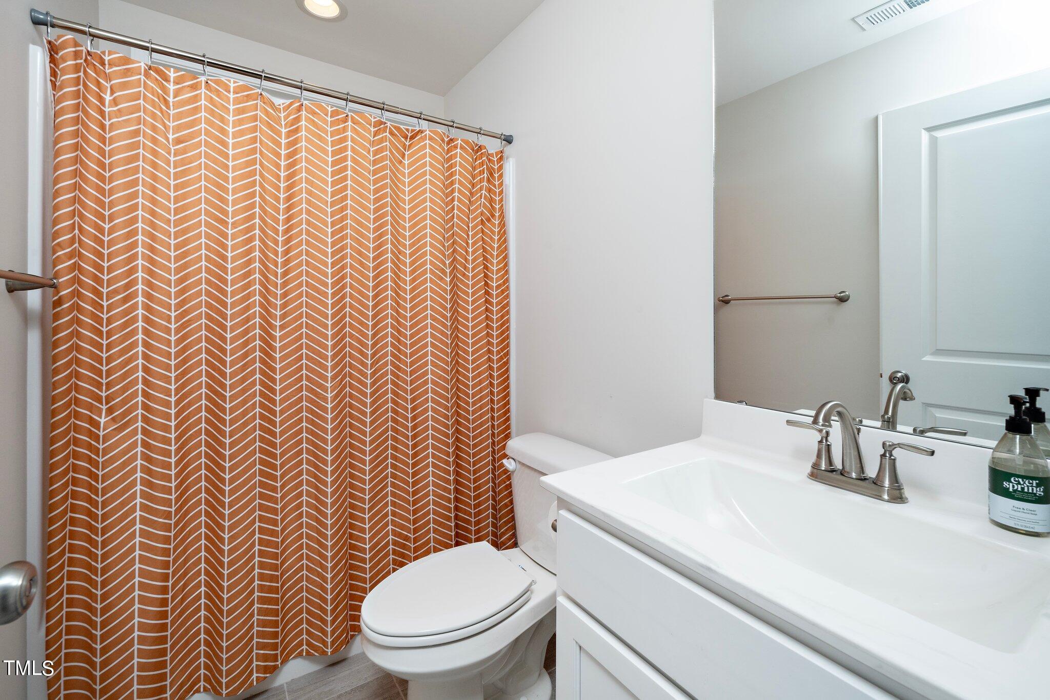 5944 Rosser Pittman Road Sanford, NC 27332 - Photo 12 of 13 a bathroom with a sink and a toilet