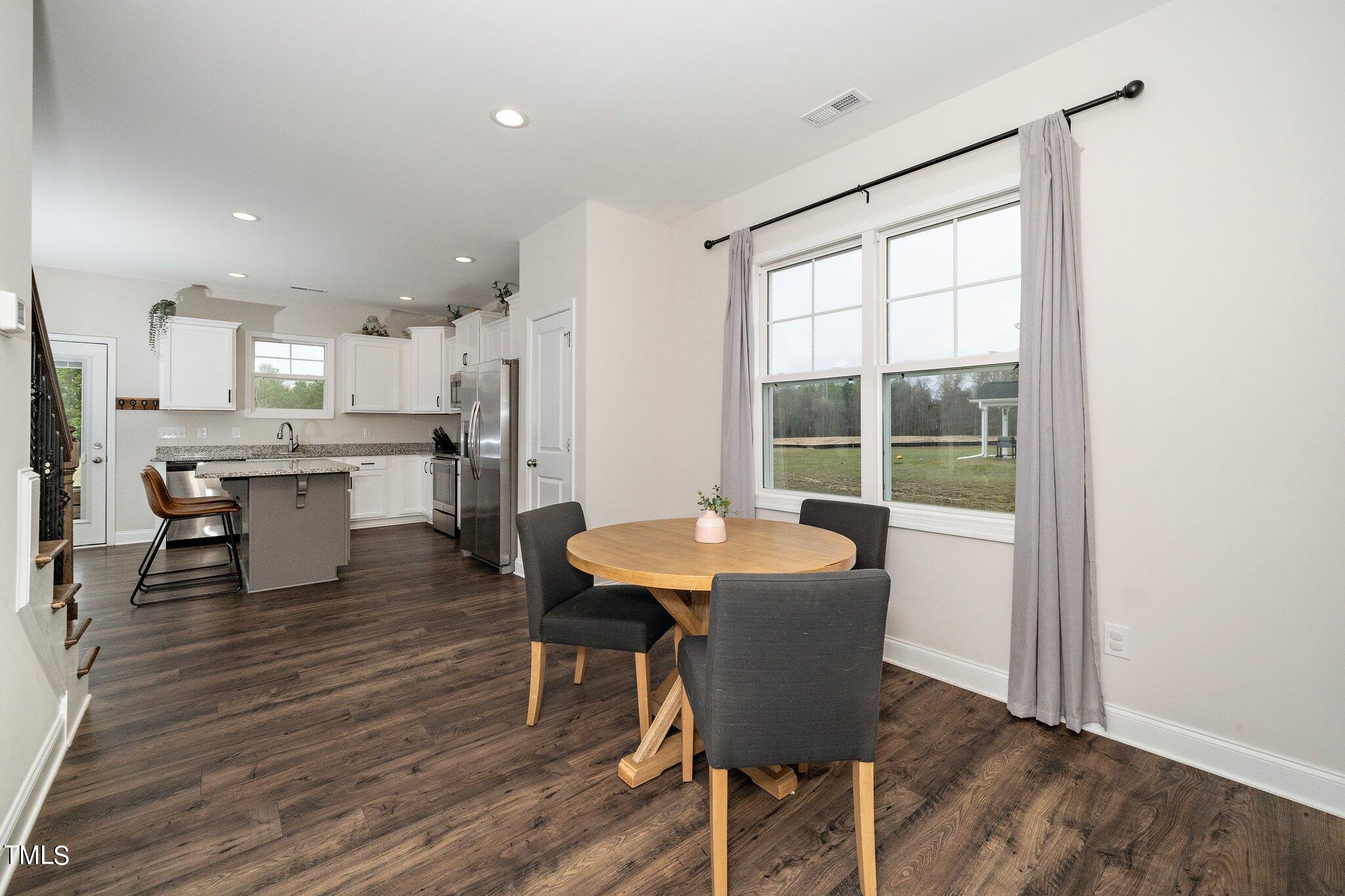 5944 Rosser Pittman Road Sanford, NC 27332 - Photo 2 of 13 a view of a dining room with furniture and wooden floor