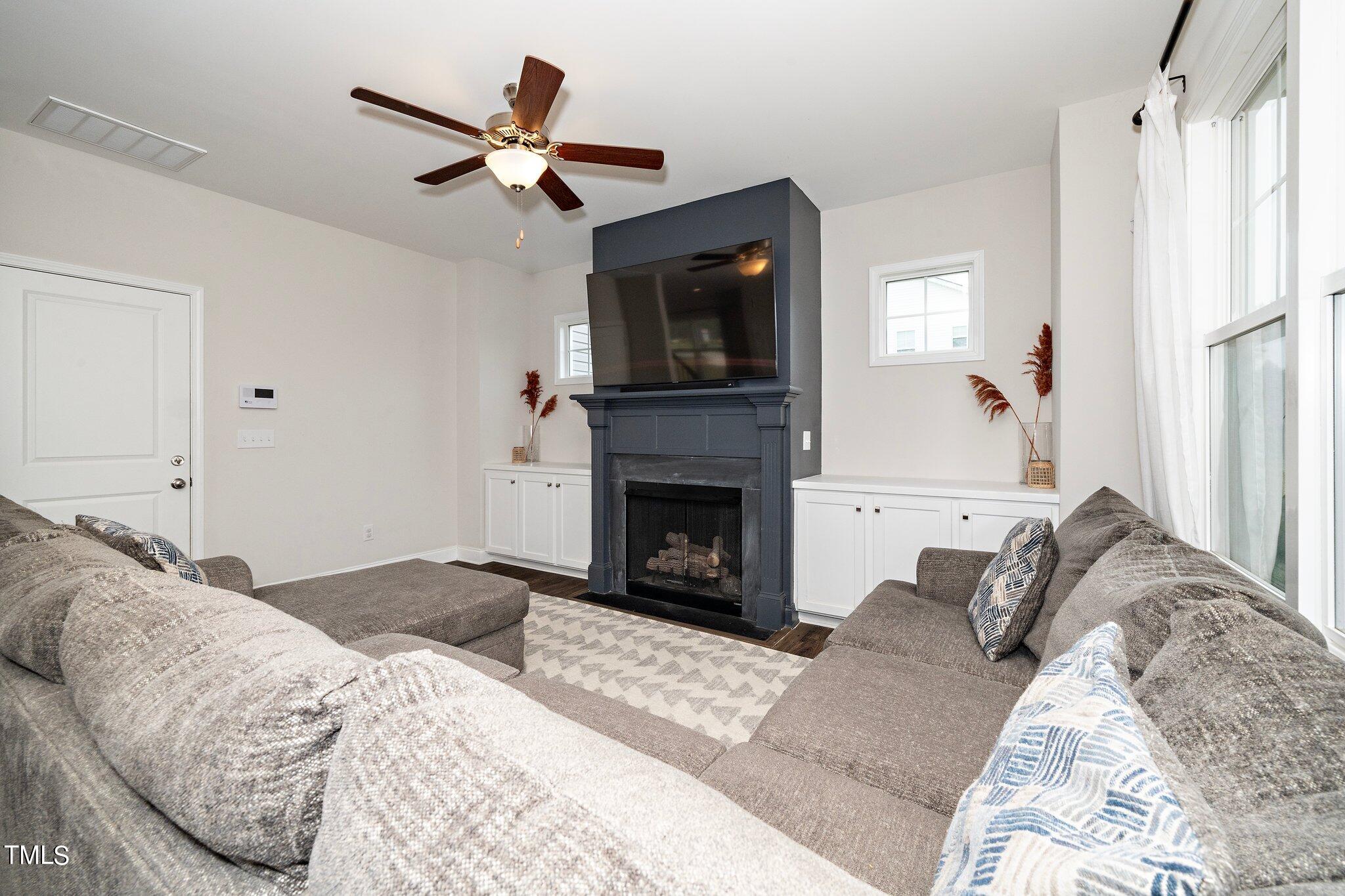 5944 Rosser Pittman Road Sanford, NC 27332 - Photo 6 of 13 a bedroom with a large bed and a fireplace