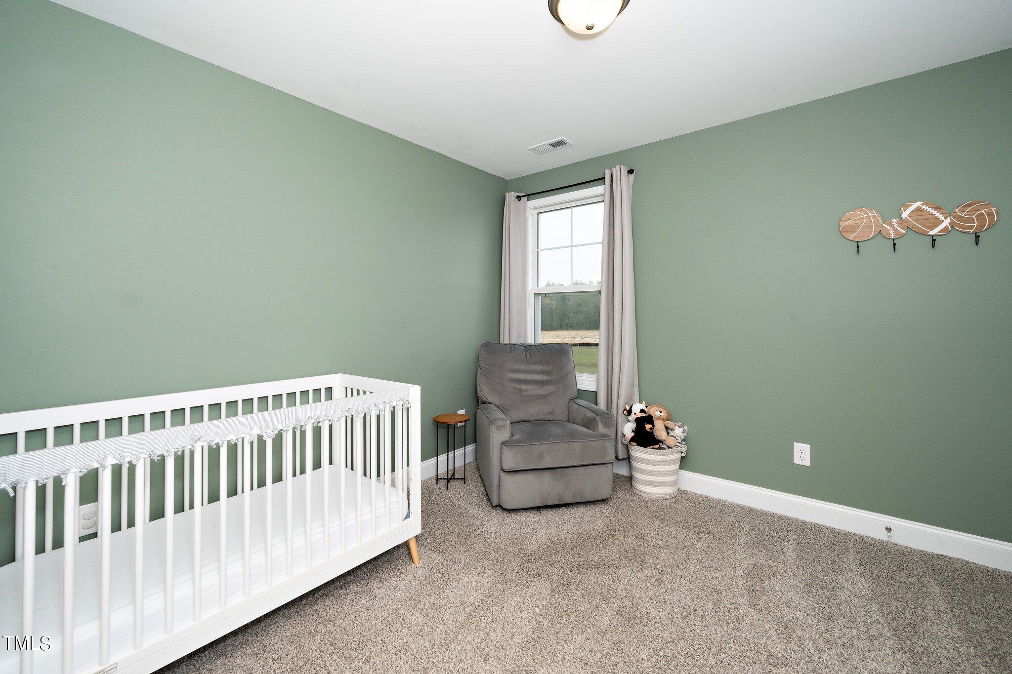 5944 Rosser Pittman Road Sanford, NC 27332 - Photo 10 of 13 a bedroom with a bed and window