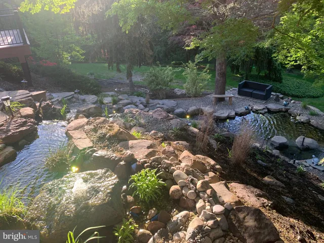 a backyard of a house with yard and outdoor seating