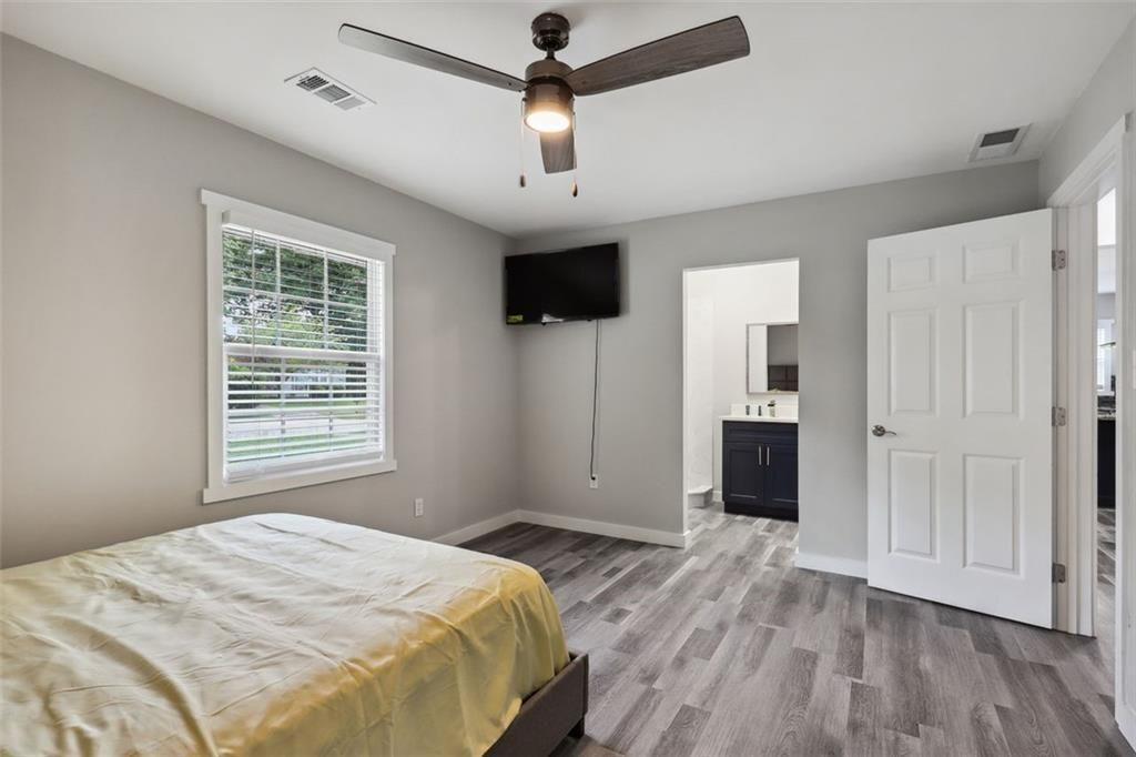 1561 Pontiac Place Southeast Atlanta, GA 30315 - Photo 12 of 14 a bedroom with a bed and a flat screen tv