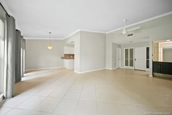a view of empty room with wooden floor and cabinet