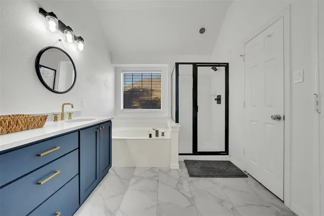 a bathroom with a double vanity sink a mirror and a bathtub