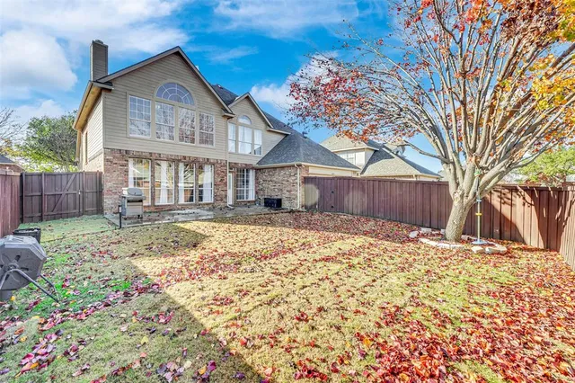 a front view of a house with a yard covered with snow