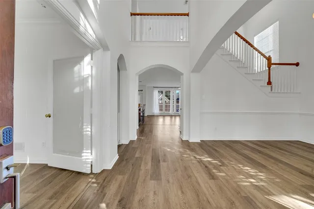 a view of a hallway view with wooden floor and staircase