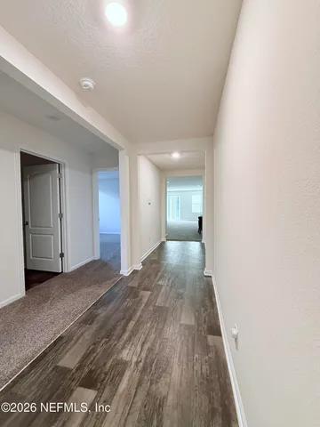 a view of hallway with wooden floor