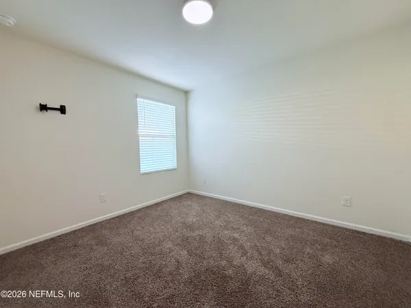 an empty room with windows and entrance