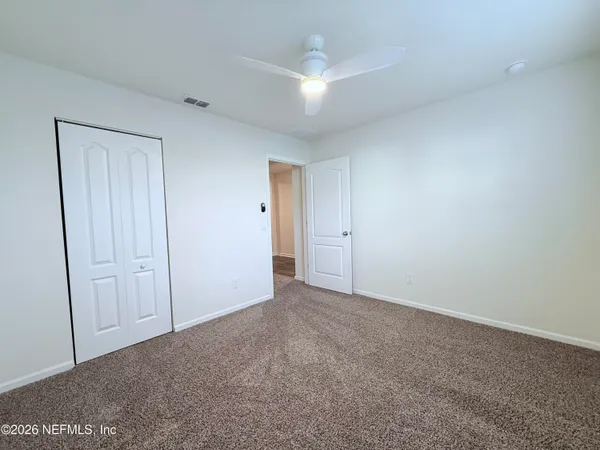 a view of an empty room and closet area