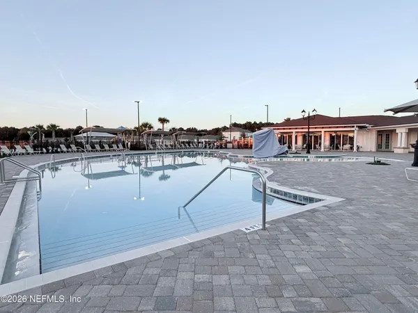 a view of a swimming pool with outdoor seating