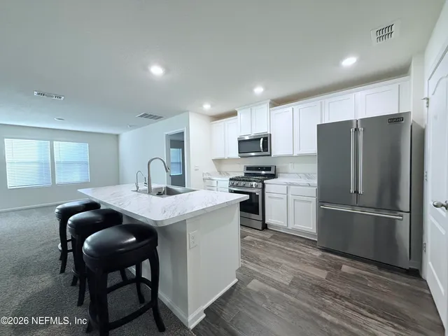 a kitchen with refrigerator cabinets and furniture