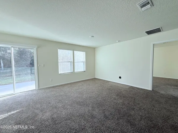 a view of an empty room with glass door
