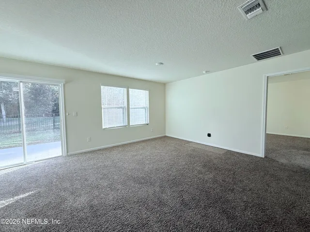 a view of an empty room with glass door