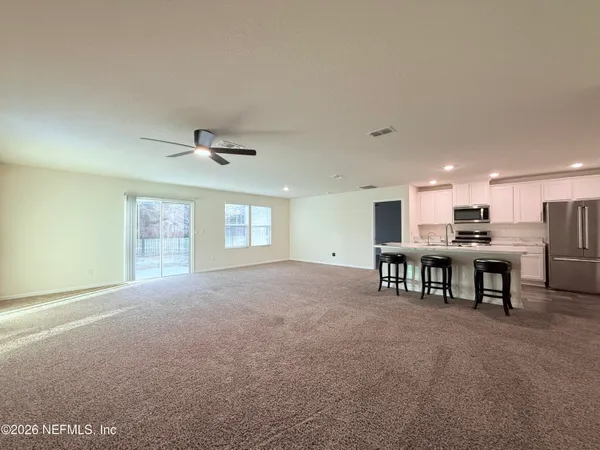 a view of a livingroom with furniture and a ceiling fan