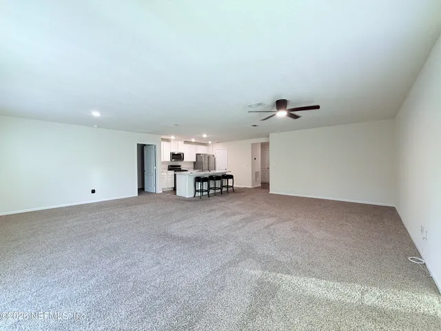 a view of a livingroom and a kitchen