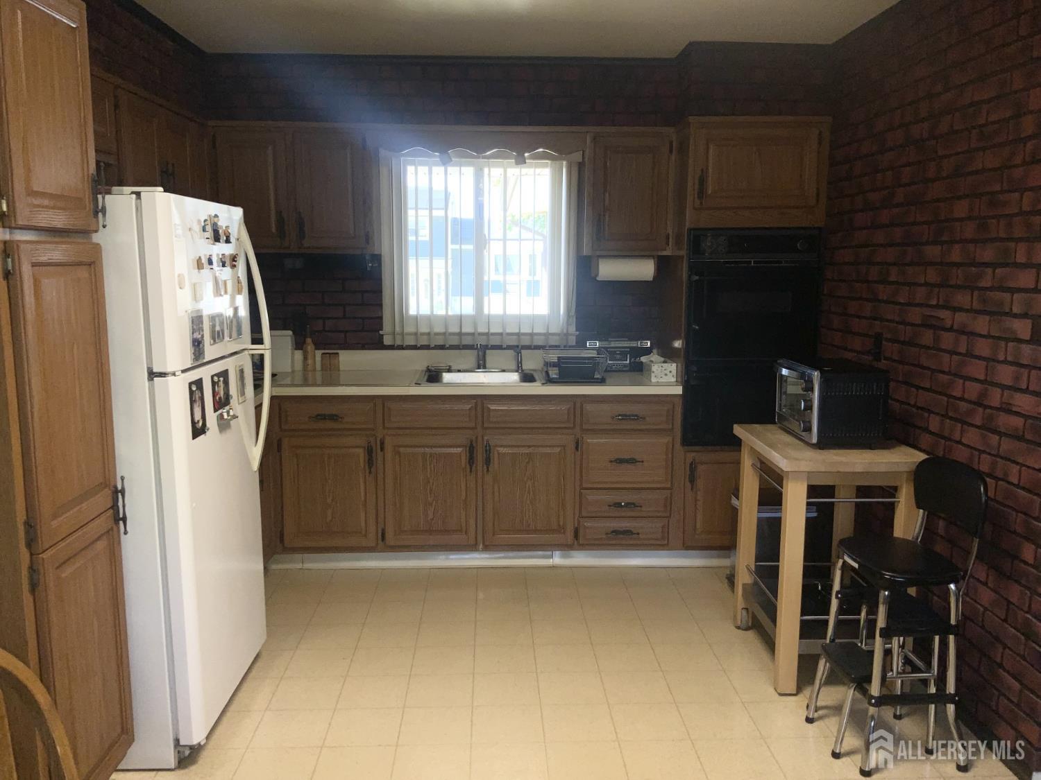 178 Willow Street Port Reading, NJ 07064 - Photo 6 of 15 a kitchen with stainless steel appliances a refrigerator and a stove top oven