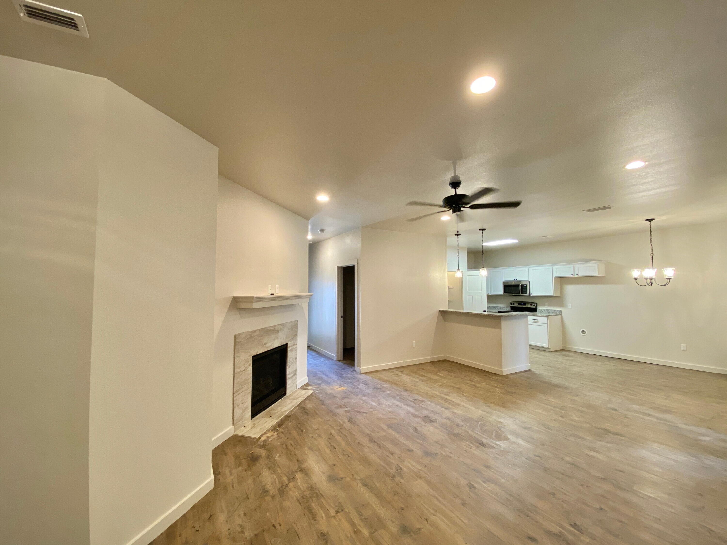 2729 137th Street Lubbock, TX 79423 - Photo 2 of 12 a view of a kitchen with a sink and a fireplace
