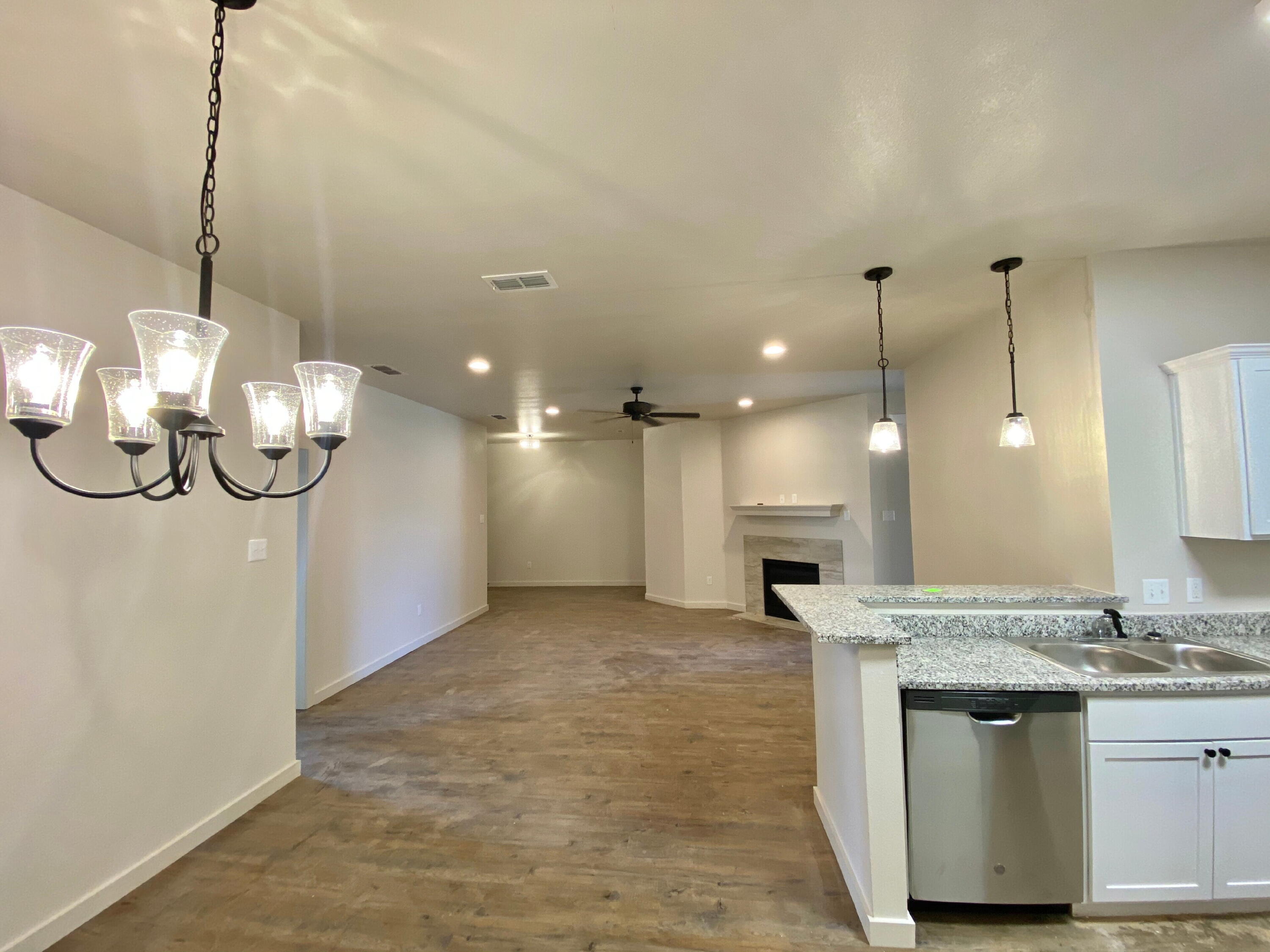 2729 137th Street Lubbock, TX 79423 - Photo 3 of 12 a view of a kitchen with a sink and chandelier
