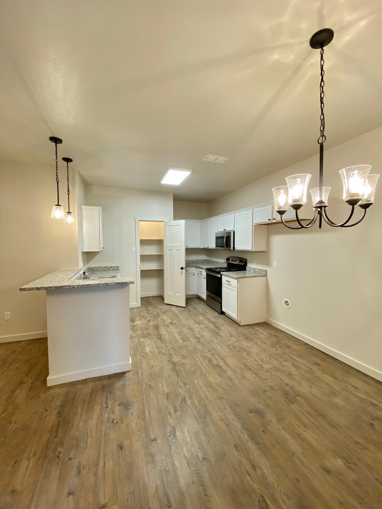 2729 137th Street Lubbock, TX 79423 - Photo 4 of 12 a kitchen with stainless steel appliances granite countertop a sink a stove and a refrigerator