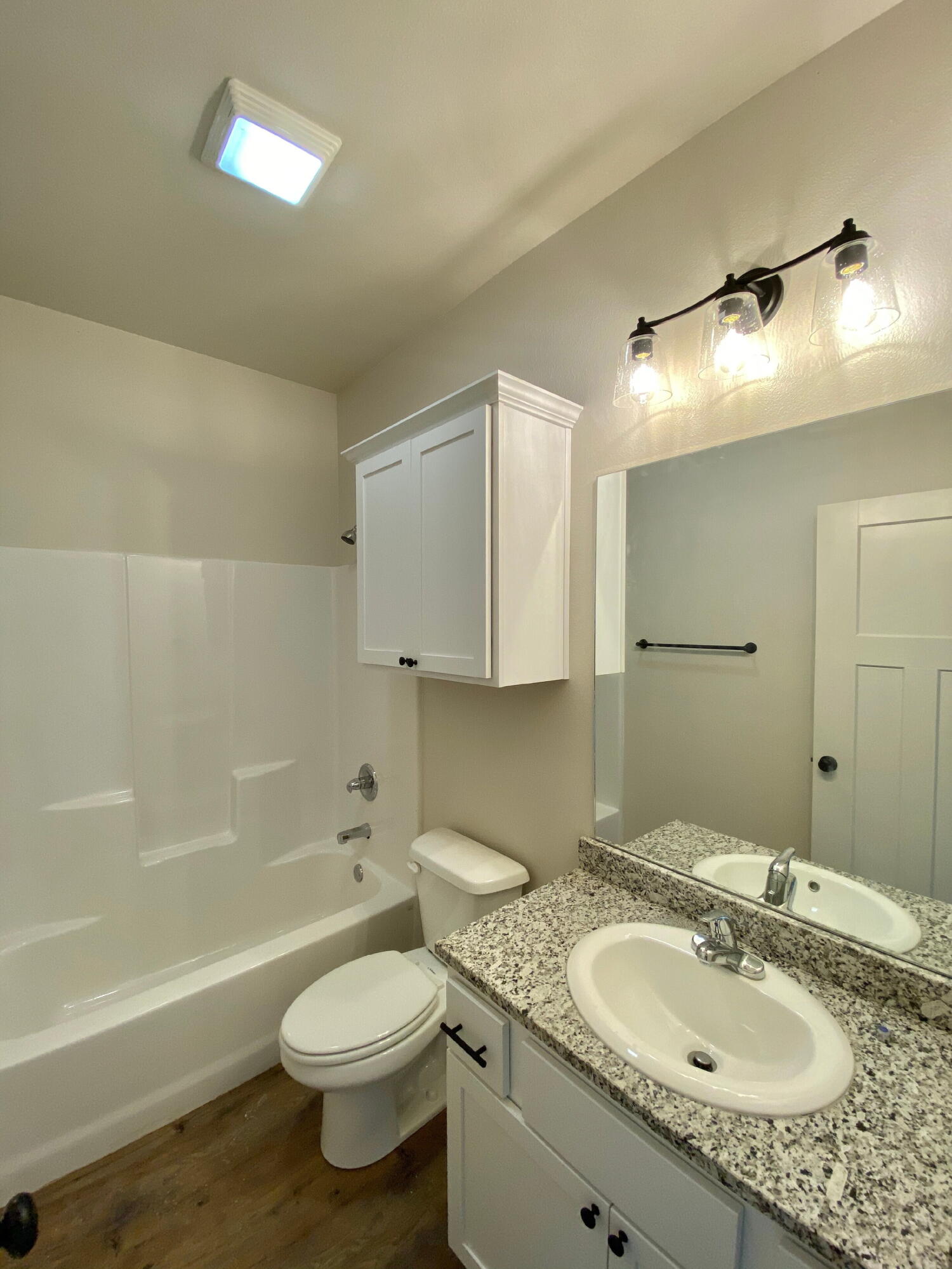 2729 137th Street Lubbock, TX 79423 - Photo 6 of 12 a bathroom with a granite countertop sink toilet and shower