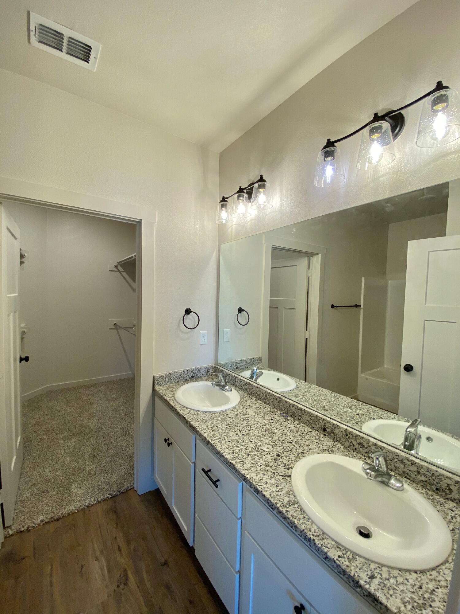 2729 137th Street Lubbock, TX 79423 - Photo 9 of 12 a bathroom with a granite countertop double vanity sink and a mirror