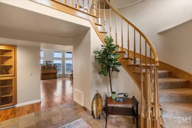 a view of entryway and hall with wooden floor
