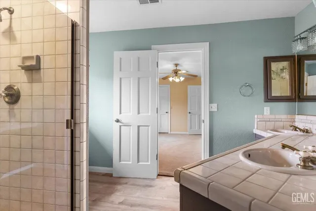 a room with wooden floor pool table and windows