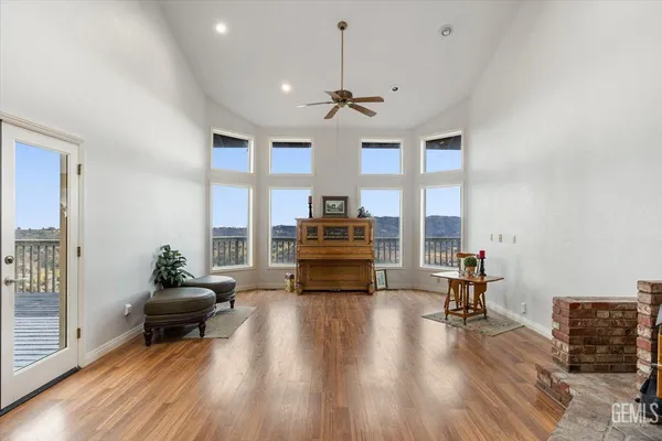 a view of a dining room and livingroom with furniture wooden floor a chandelier