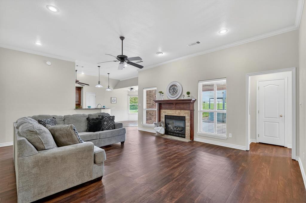 2828 Bennett Road Howe, TX 75459 - Photo 5 of 39 a living room with furniture a fireplace and a flat screen tv