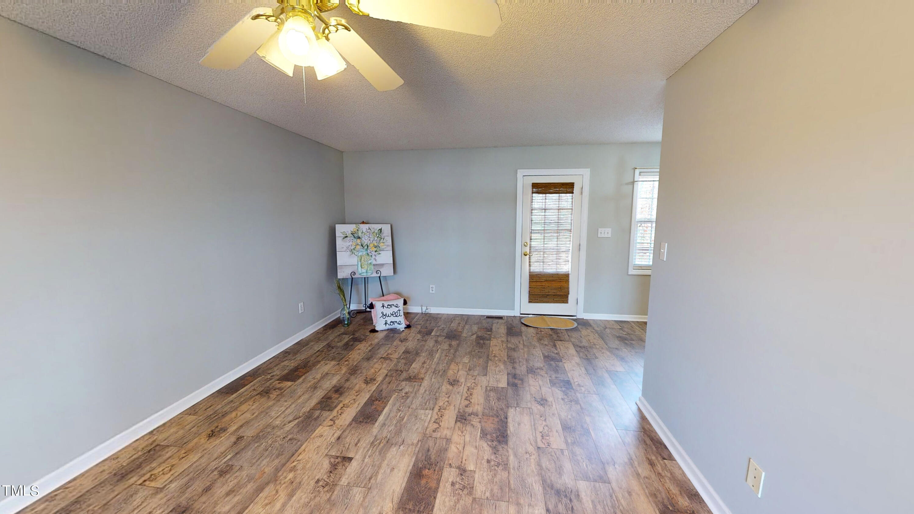 115 Stoneview Circle Smithfield, NC 27577 - Photo 14 of 35 an empty room with wooden floor and windows