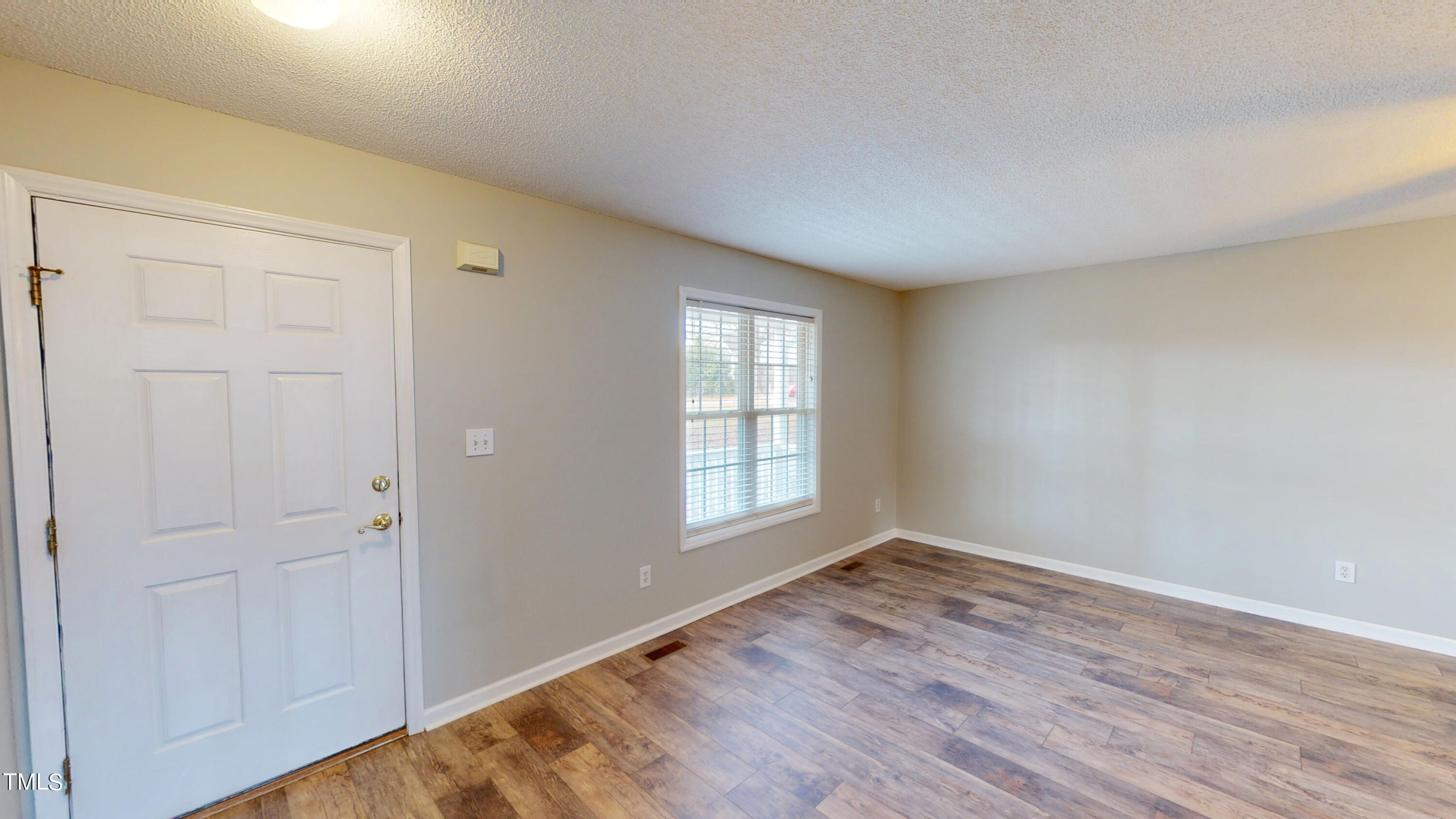 115 Stoneview Circle Smithfield, NC 27577 - Photo 23 of 35 an empty room with wooden floor and windows