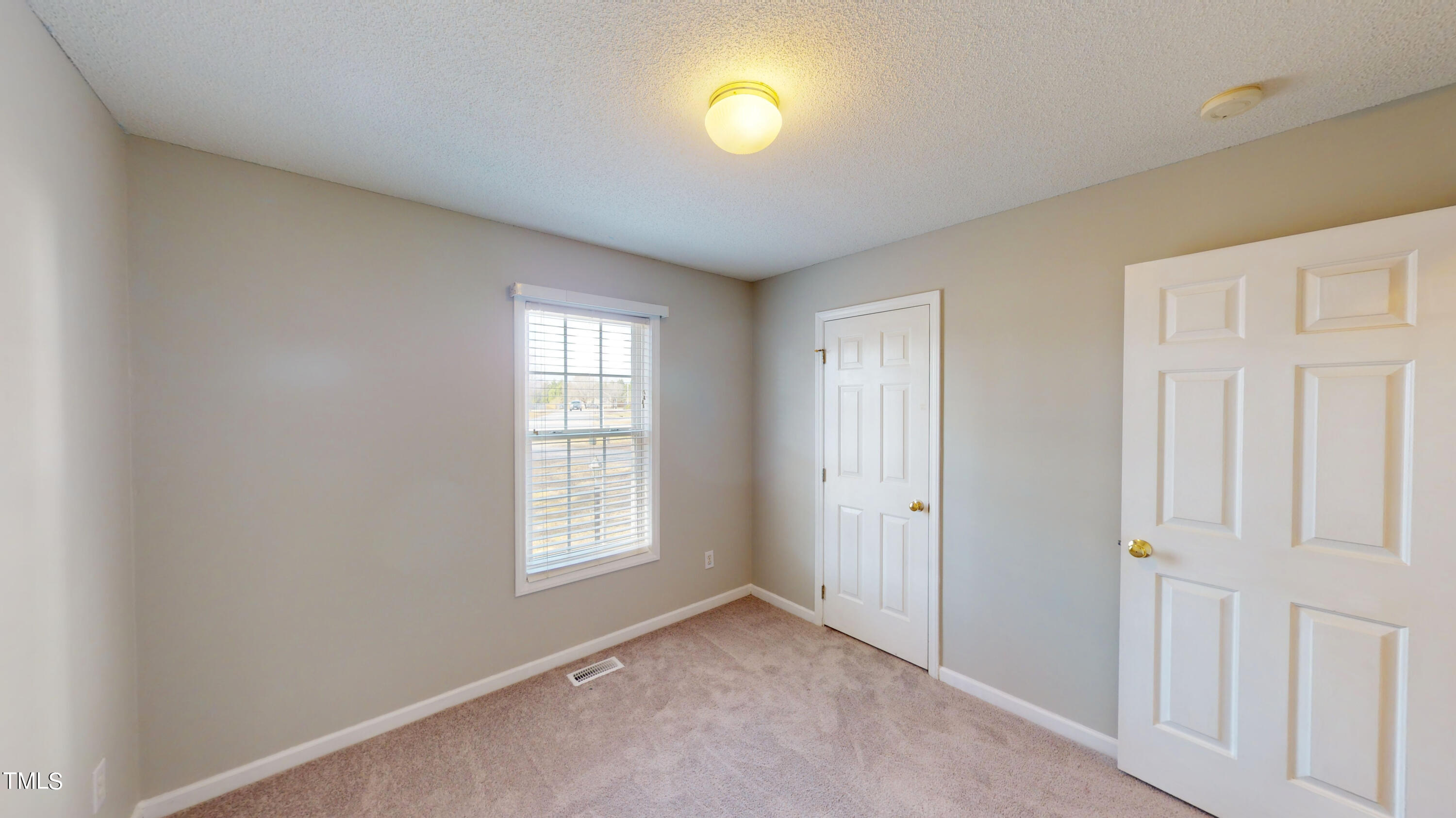 115 Stoneview Circle Smithfield, NC 27577 - Photo 24 of 35 an empty room with windows and closet