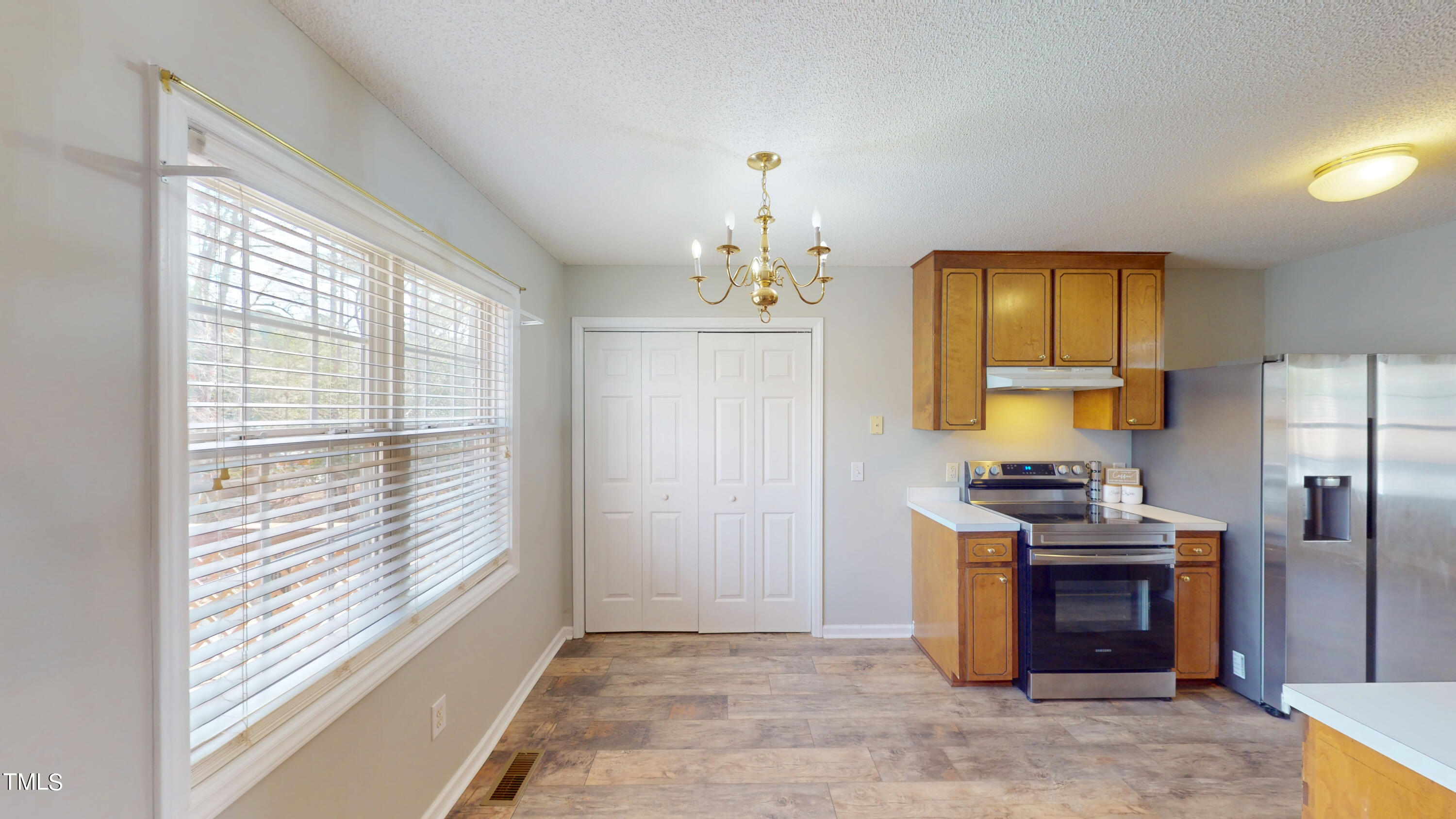 115 Stoneview Circle Smithfield, NC 27577 - Photo 9 of 35 a kitchen with a refrigerator and a stove top oven